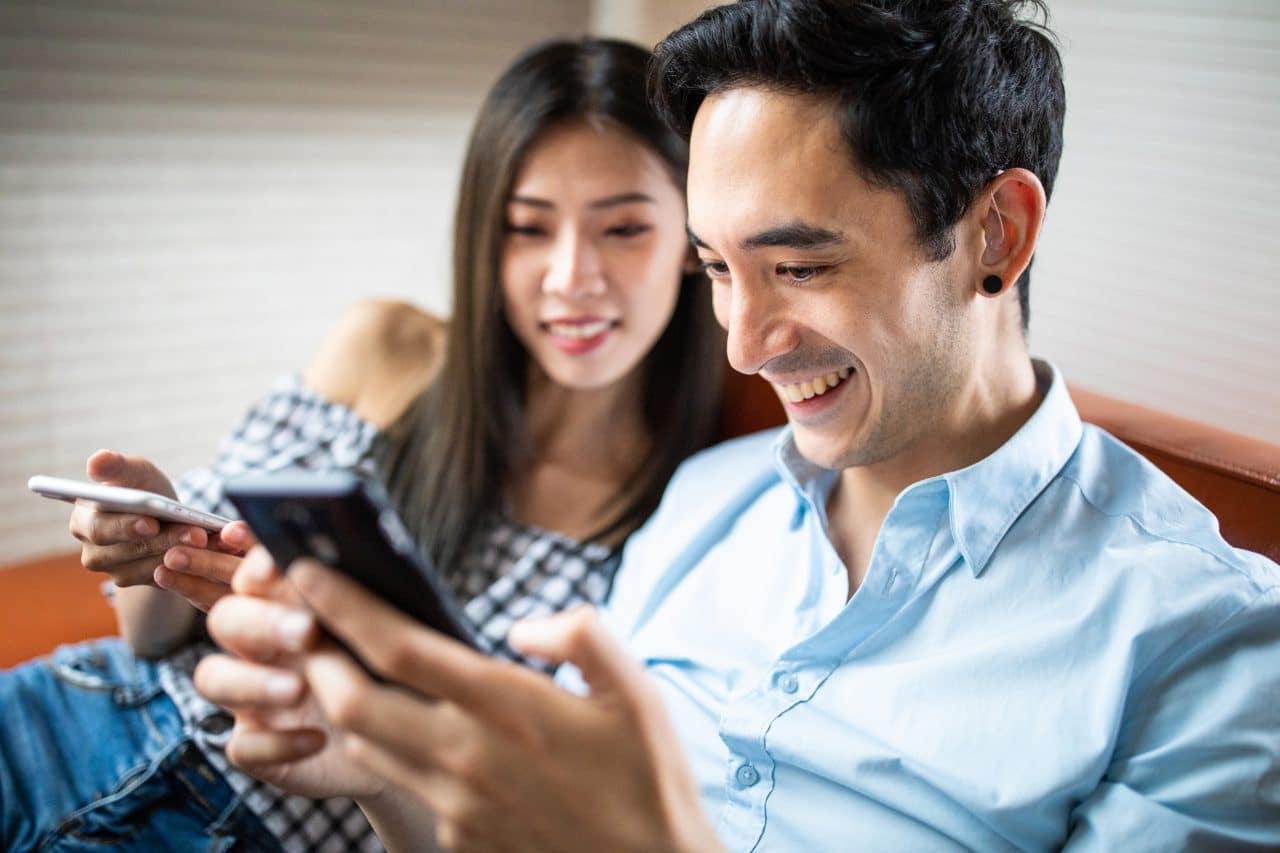 Man with hearing aids on his phone.