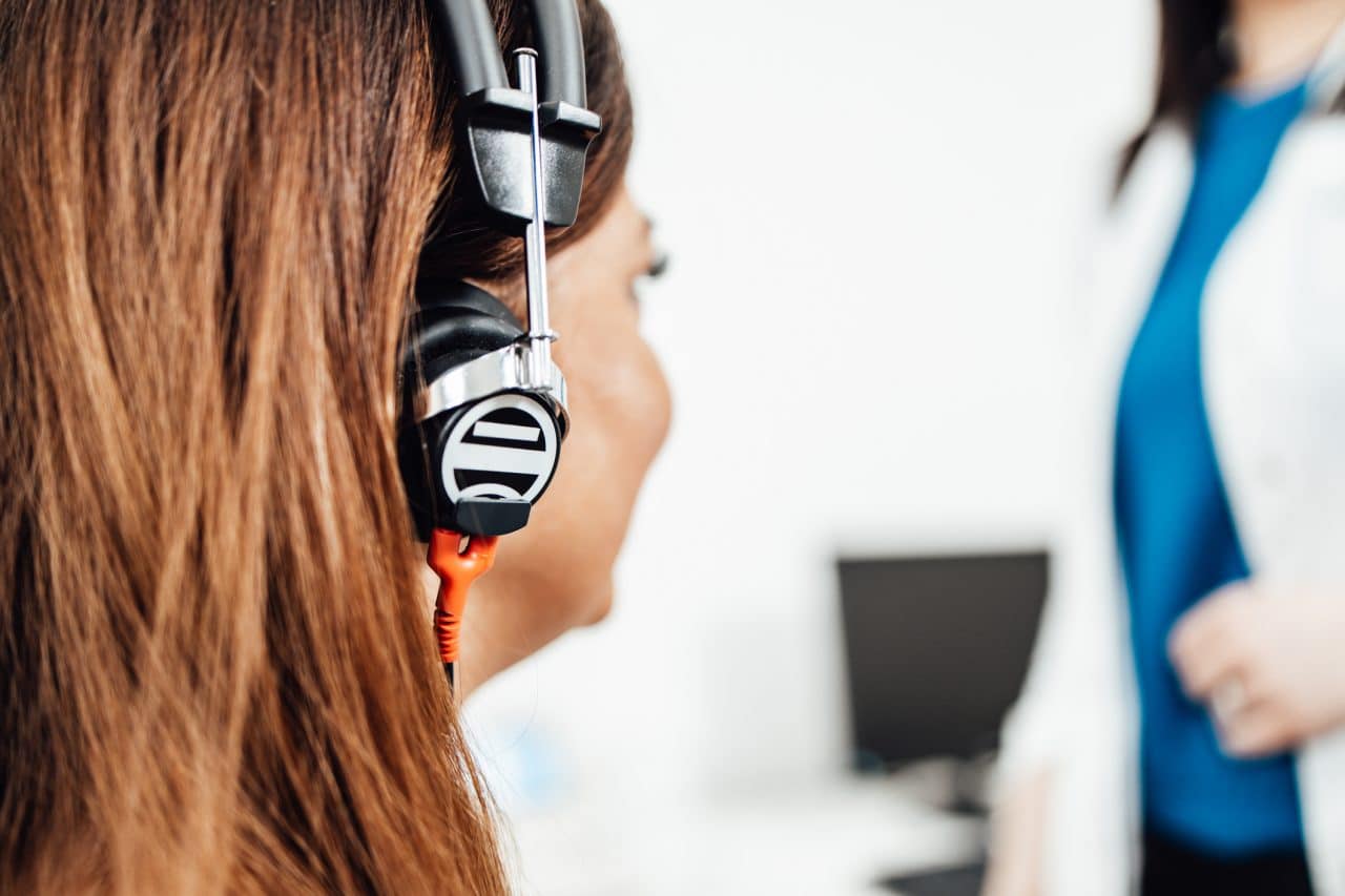 A woman getting a hearing test at an audiologist's office.