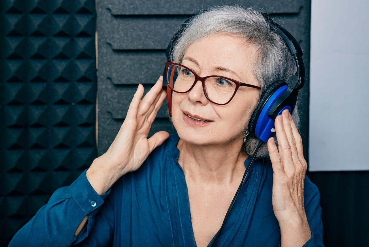 An older woman receiving a hearing test.