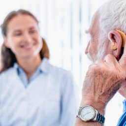 Man visiting his audiologist to talk about hearing aid issues.
