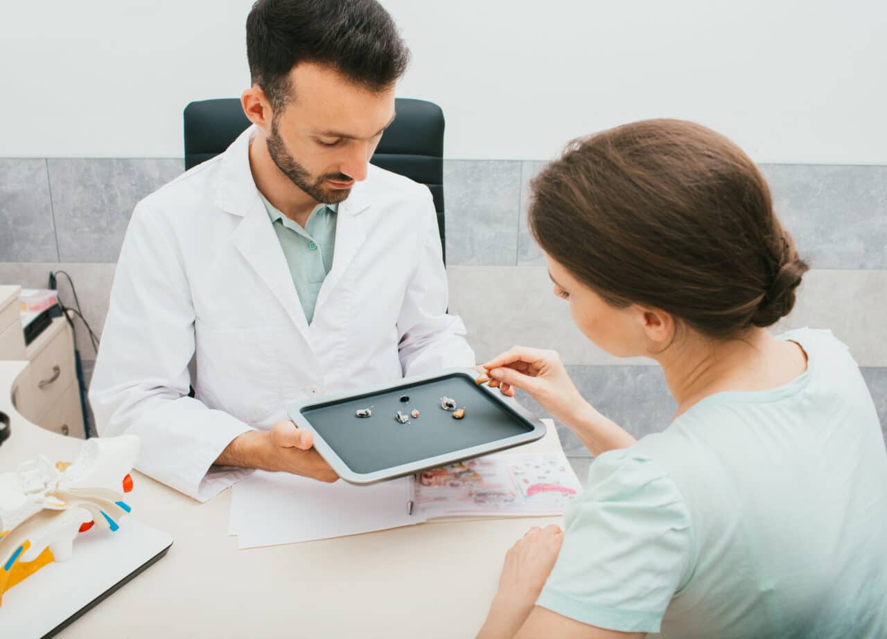 Audiologist helping a patient select the right hearing aid.