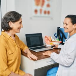 Woman attending a consultation with an audiologist to discuss hearing loss.