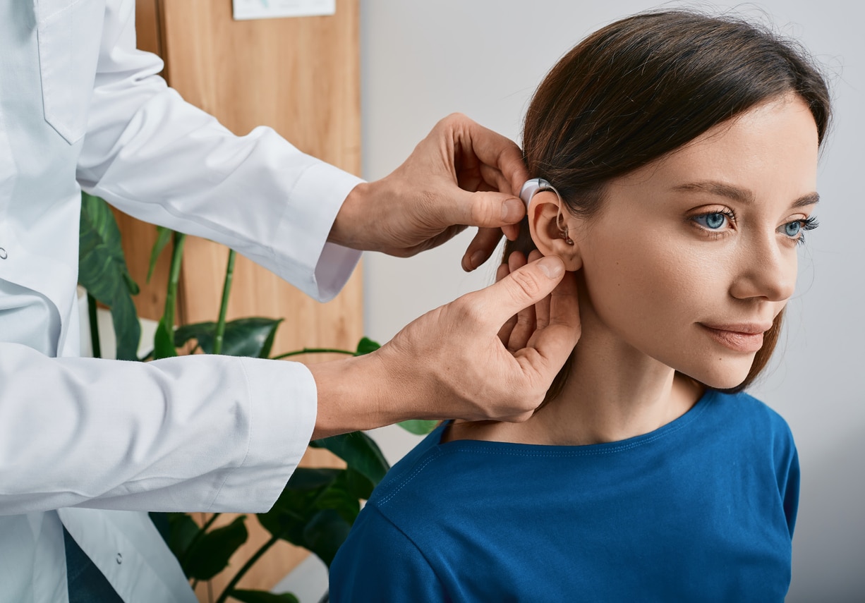 Woman wears hearing aid