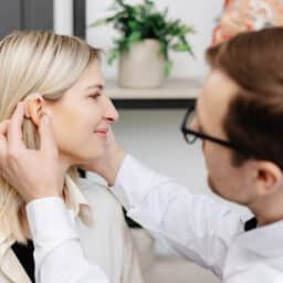 Young woman getting fit with new hearing aids