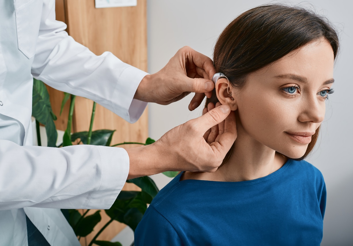 Woman getting her new hearing aid.