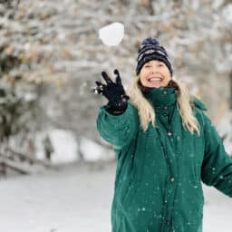 Senior woman throwing a snowball