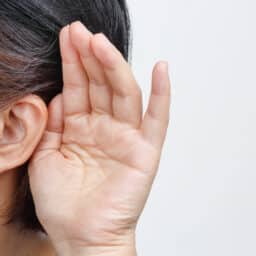 Hand to the ear, hearing concept