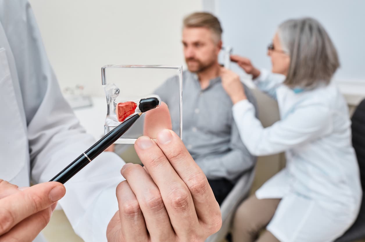 Hearing aid specialist doing ear examination and recommended Completely-in-Canal hearing aid to patient