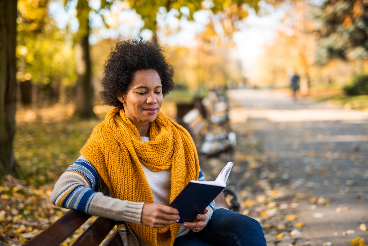 Woman reading a book in the public park